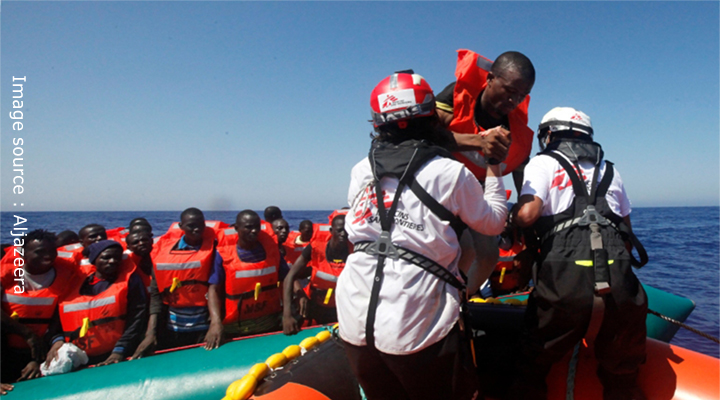 Rescue ship helping drowning refugees.