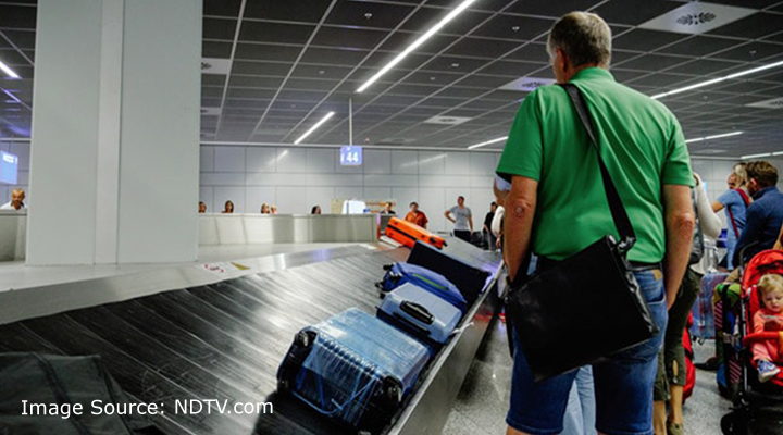 Man waiting for his luggage in airport.