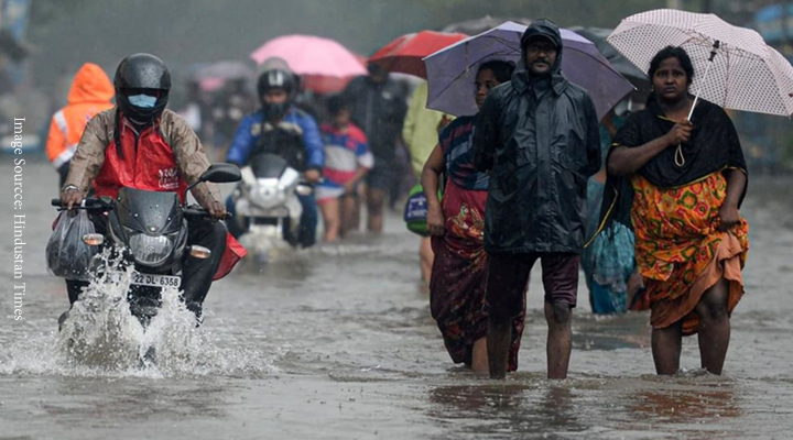 people on waterlogged raod.