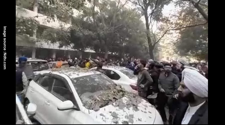 THE DEBRIS FELL ON CAR AFTER THE BLAST, PEOPLE GATHERED AROUND IT